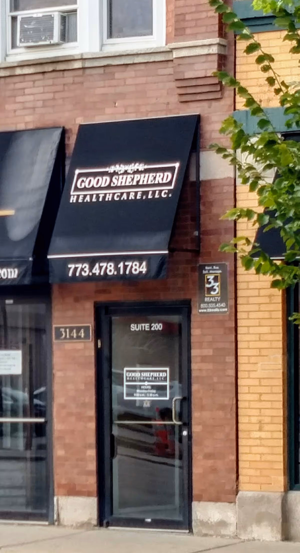Brick storefront with Good Shepherd Healthcare signage and a black awning over the entrance.