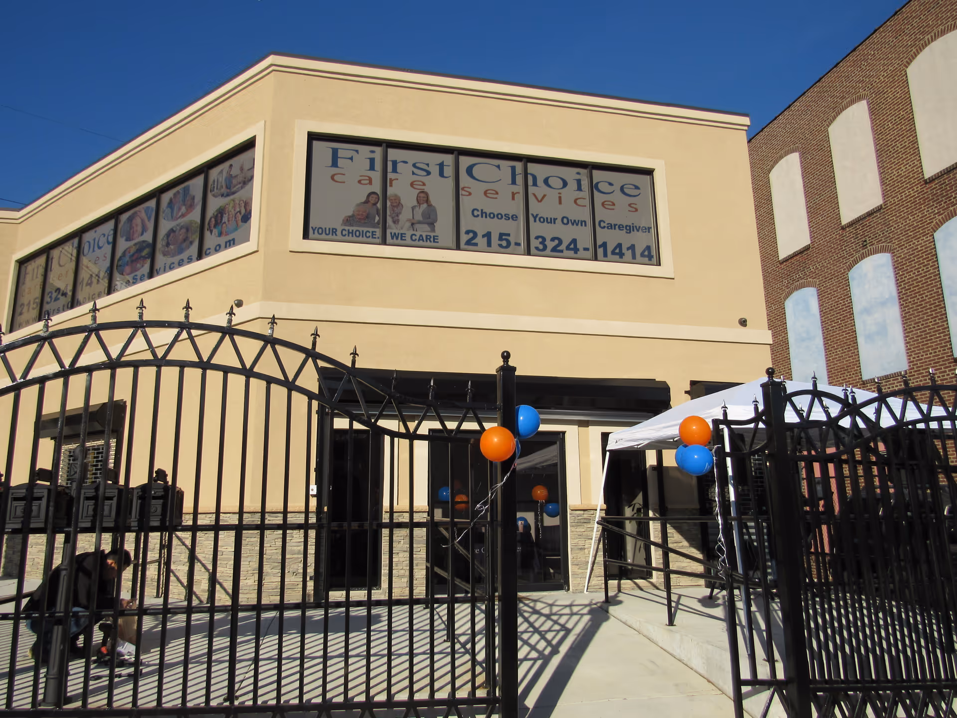 Exterior view of a beige building labeled First Choice Care Services with a gated entrance.