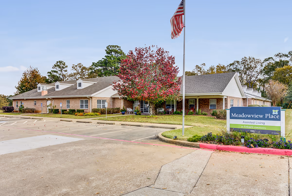 Exterior of Meadowview Place assisted living facility with flagpole and front entrance.