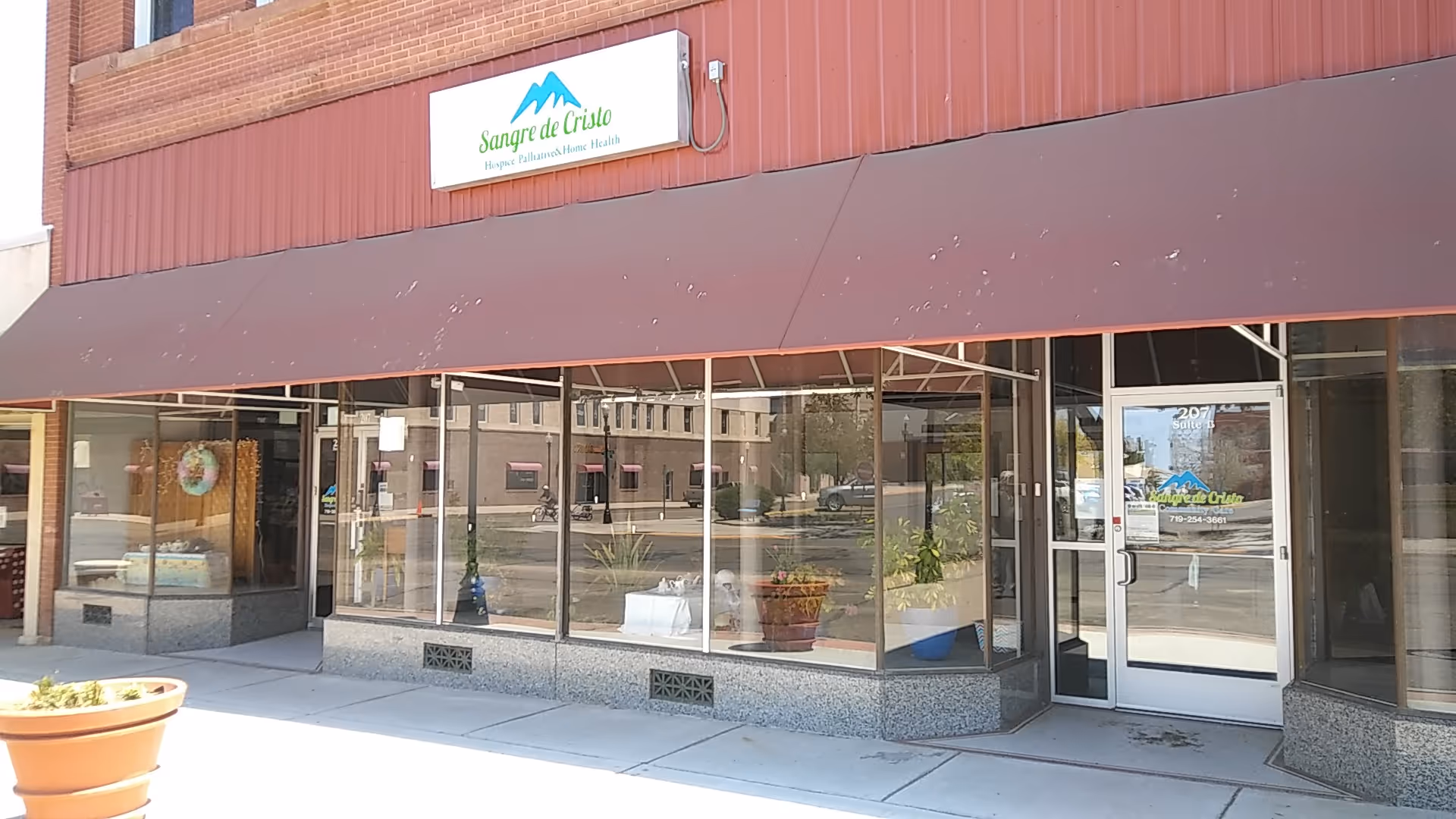 Exterior storefront of Sangre de Cristo Community Care with large glass windows and entrance.