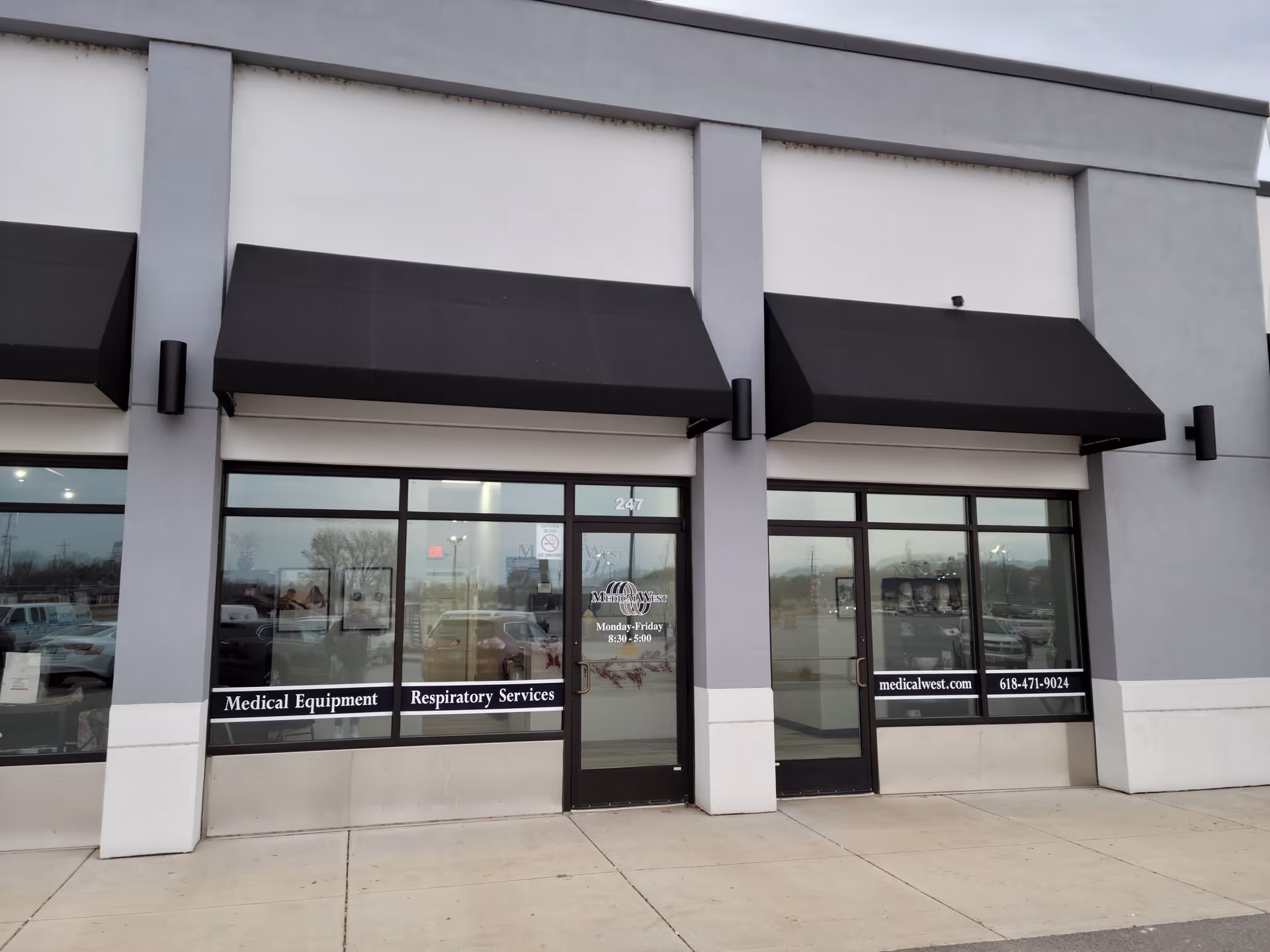 Exterior view of a Medical West storefront with glass doors and black awnings.