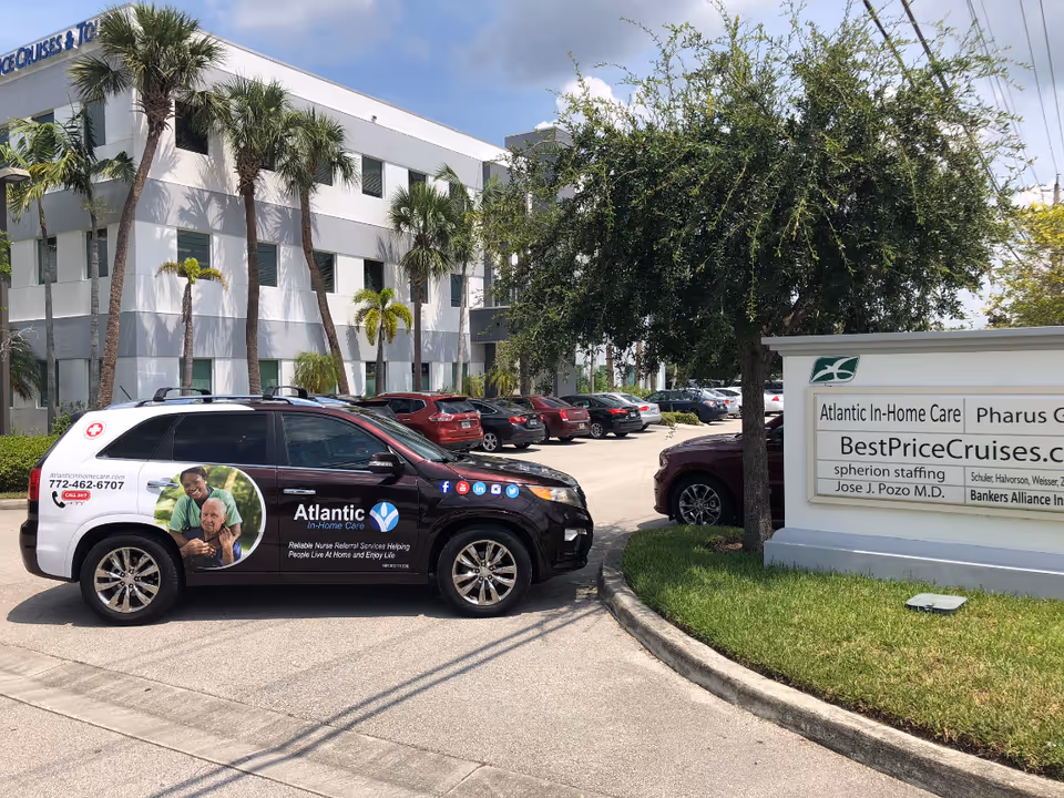 Exterior view of Atlantic In-Home Care building with a parked branded van and sign.