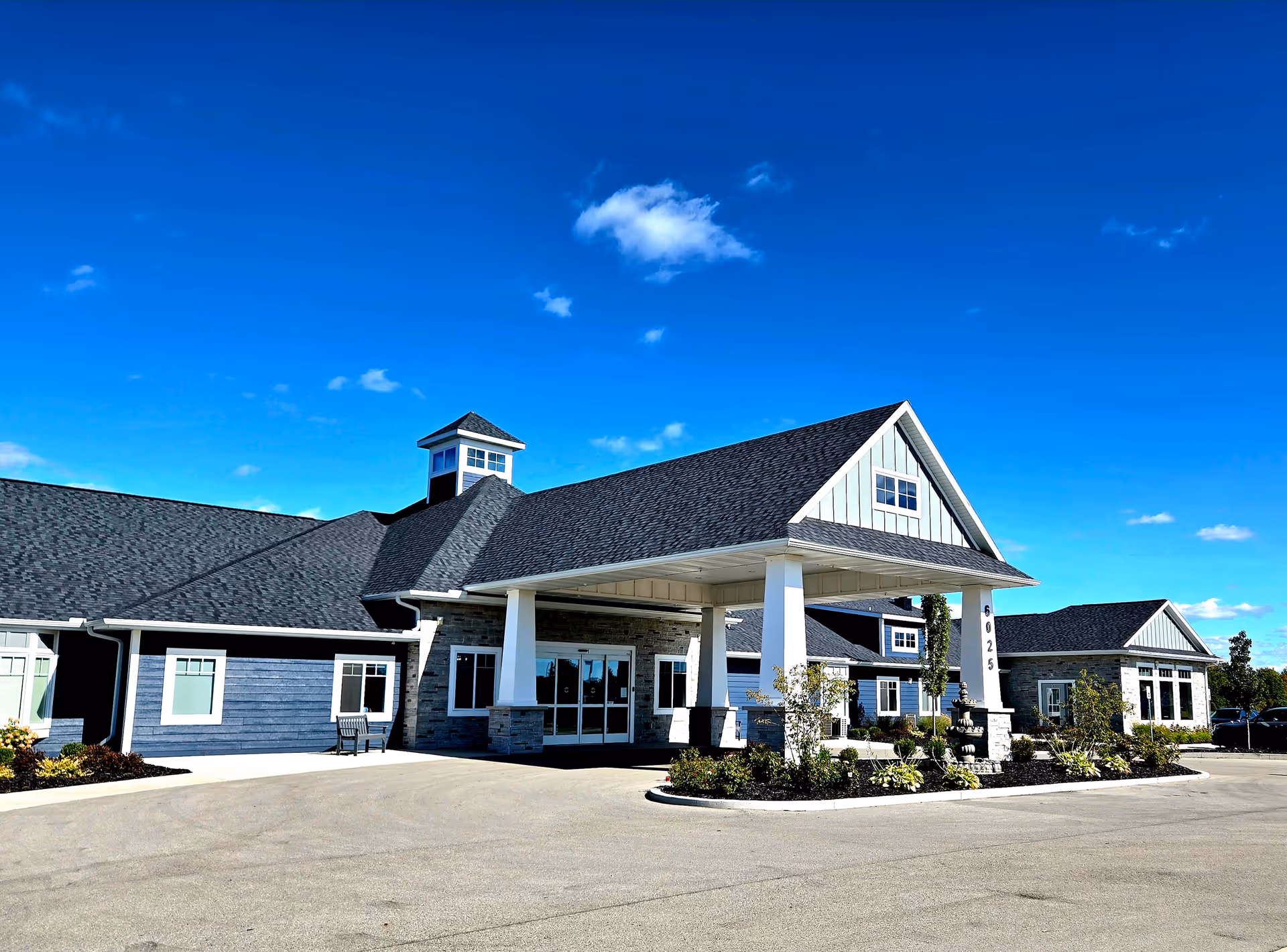 Exterior view of The Oasis of Norton Shores senior living facility entrance.