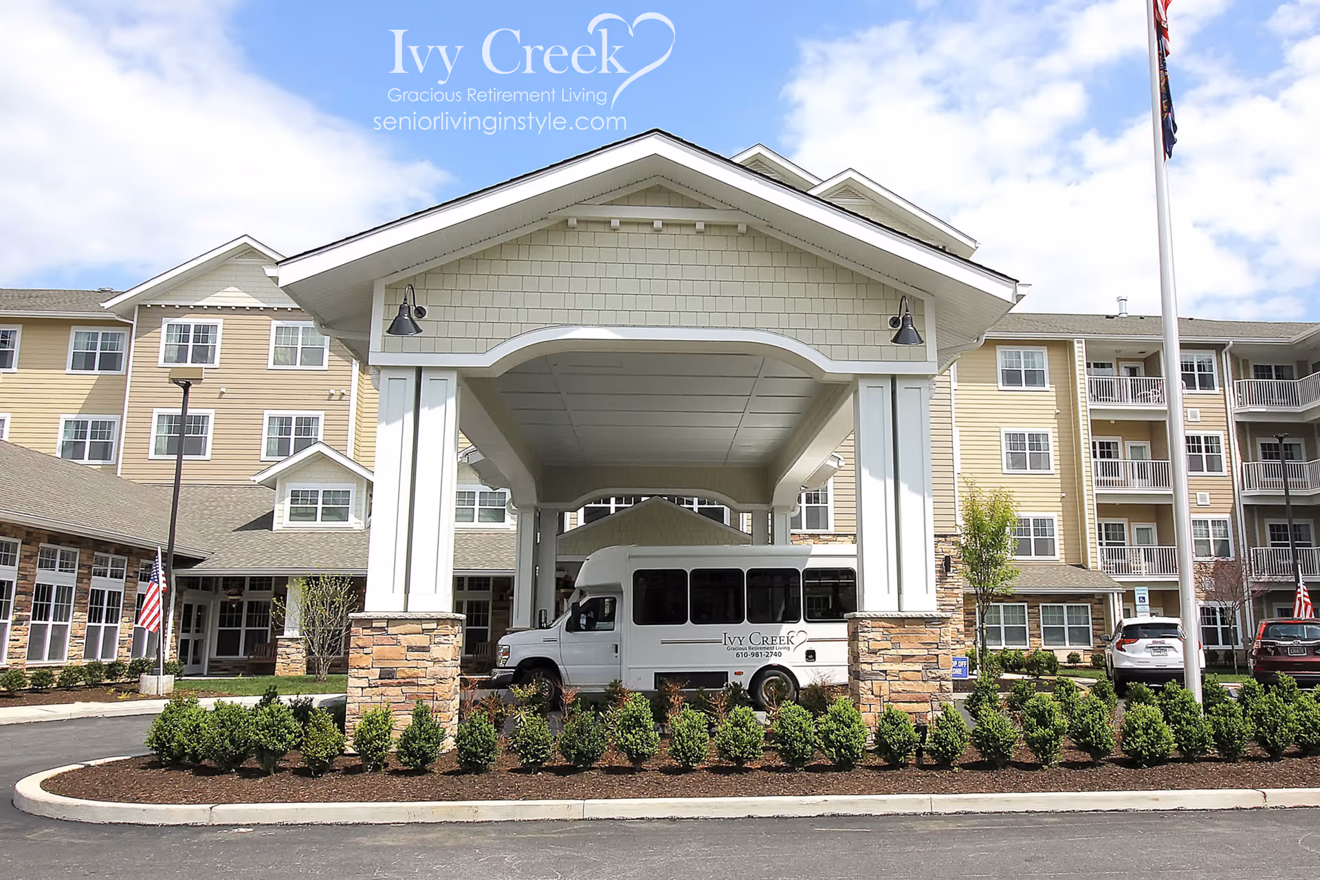 Front entrance of Ivy Creek retirement building with a covered porte-cochere and shuttle bus