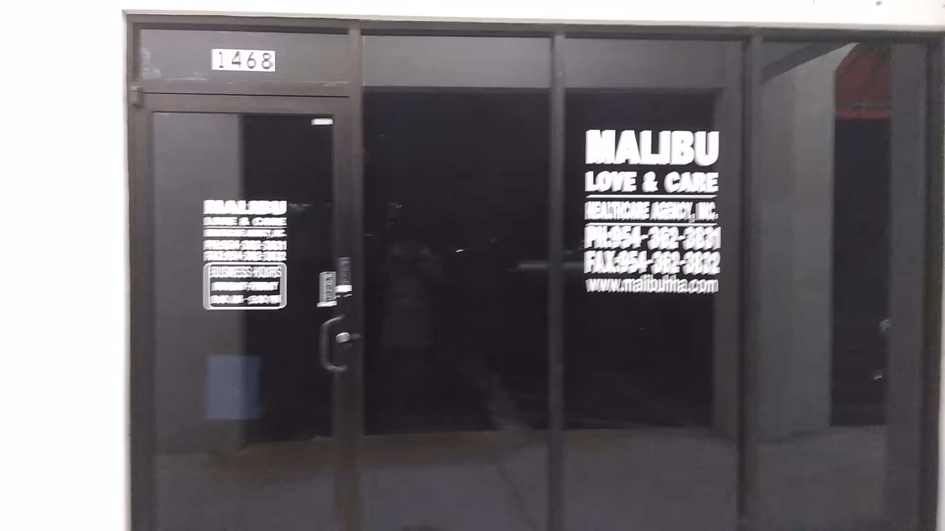 Glass storefront entrance with Malibu Love & Care signage on the front doors.
