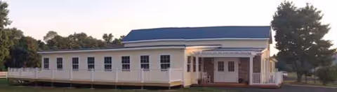 Exterior view of Chesapeake Cottage Assisted Living building with a covered entrance.
