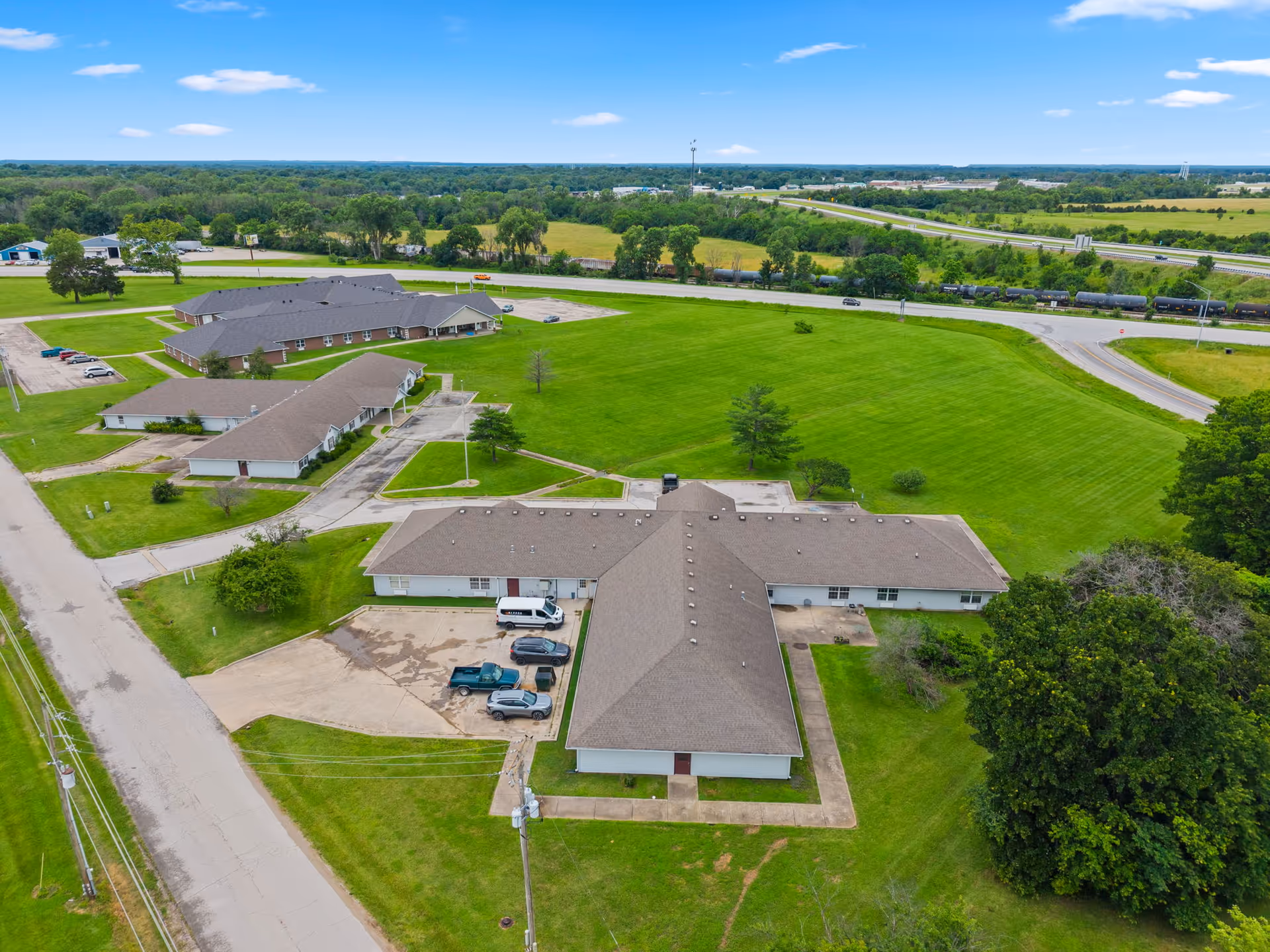 Aerial view of Joe Clark Residential Care Home campus with several buildings and green fields.