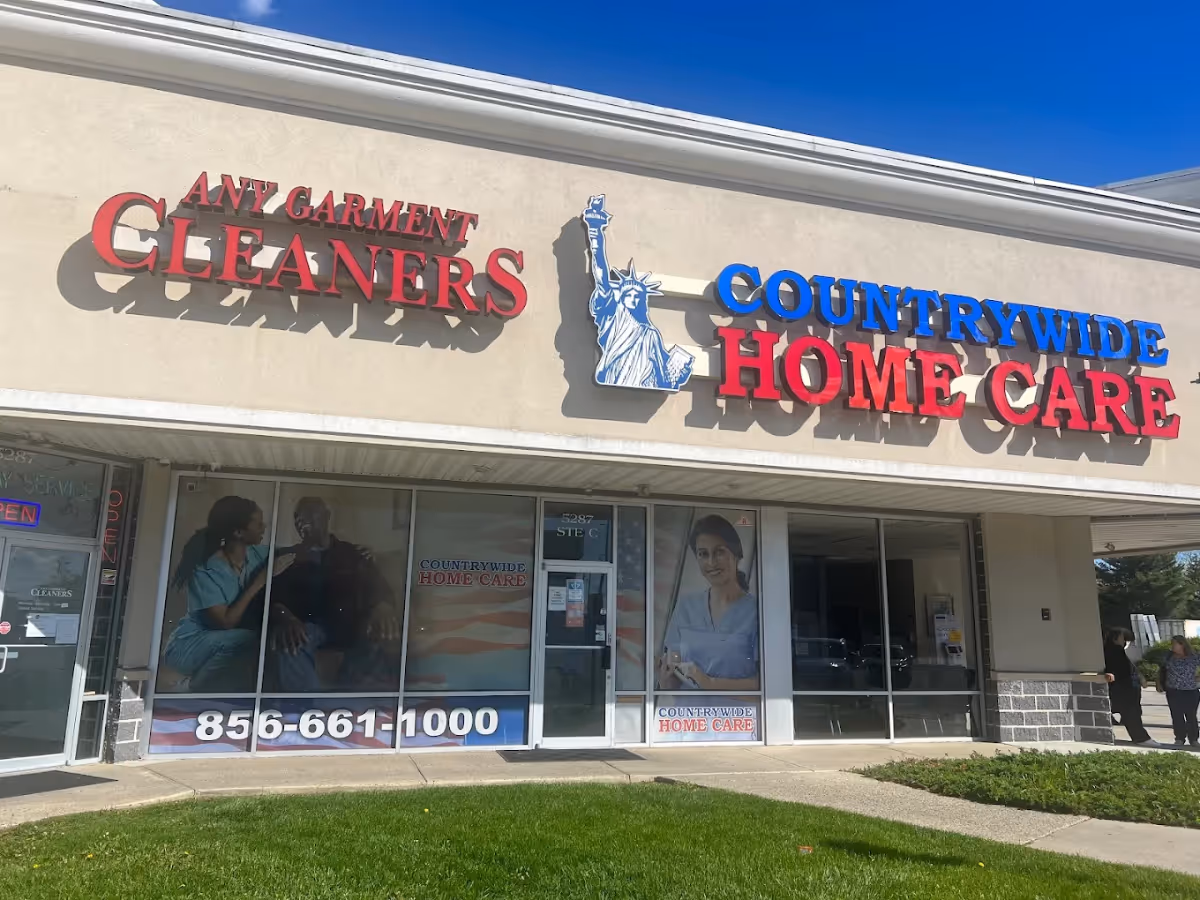 Exterior storefront showing Countrywide Home Care sign and neighboring cleaners shop.