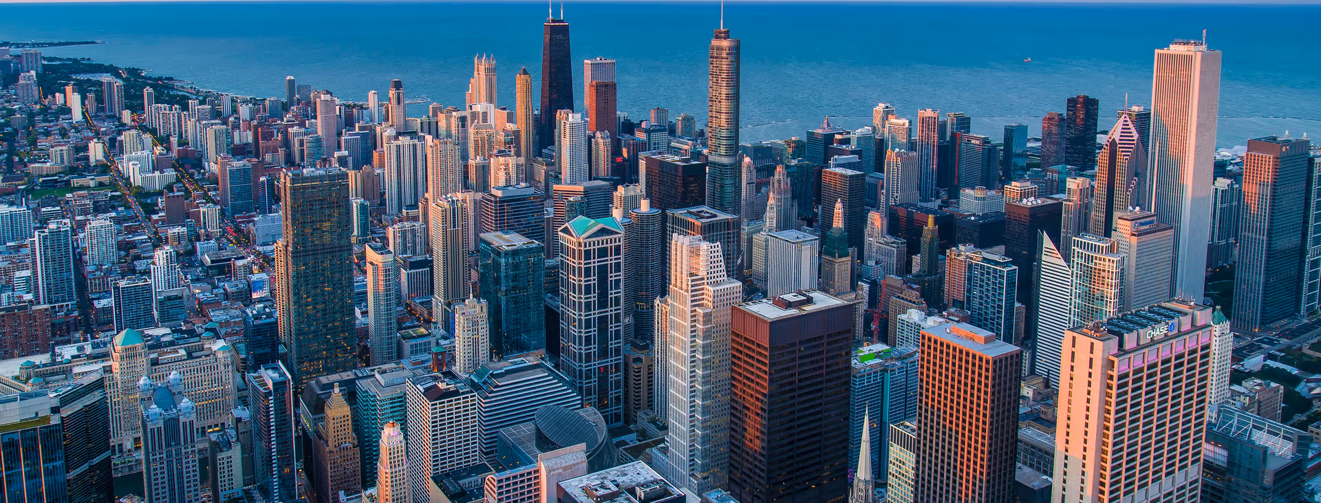 Aerial view of a dense city skyline with numerous tall skyscrapers.