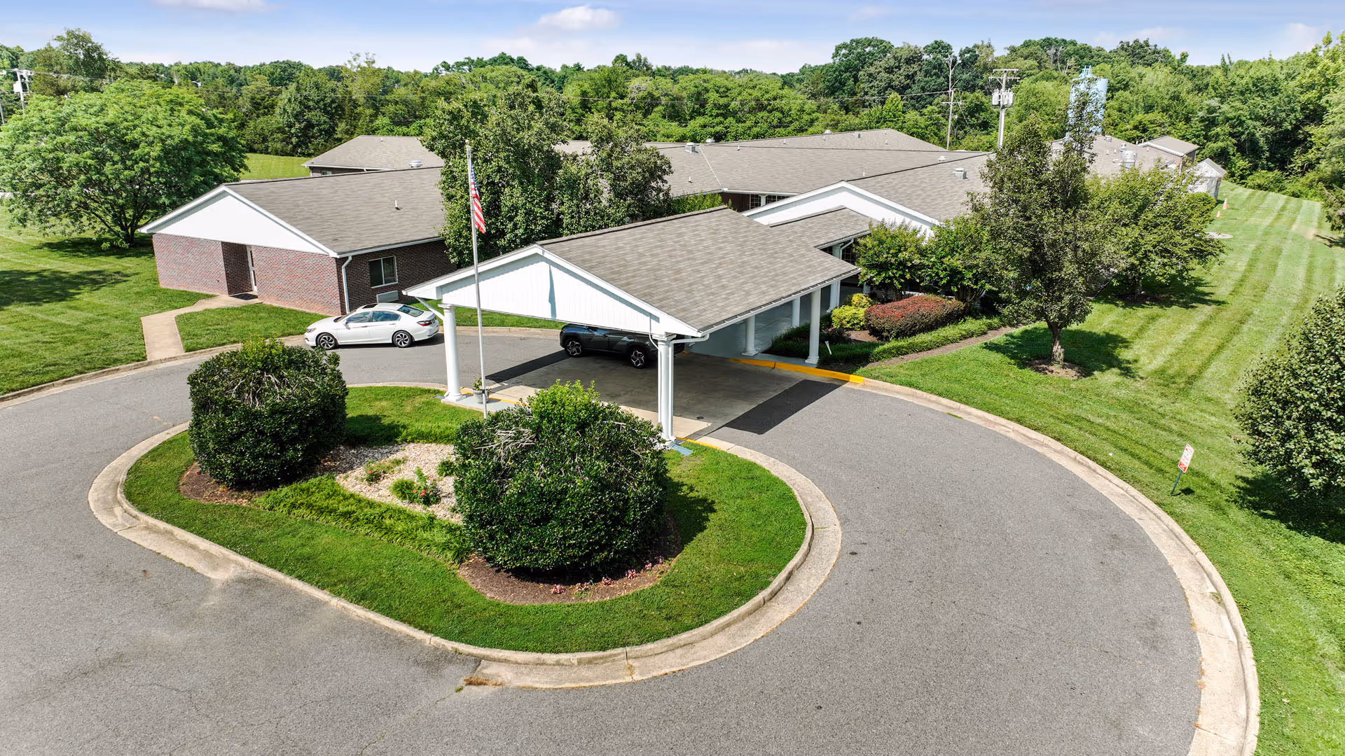 Aerial view of Meadows Nursing Center with circular driveway and green lawns.