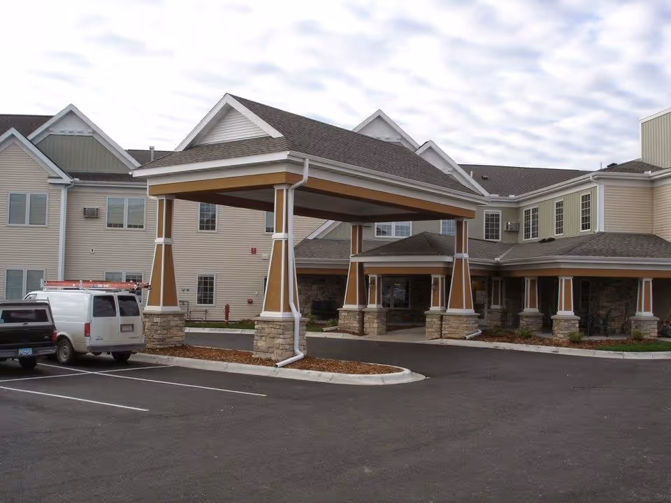Exterior view of Park Terrace Assisted Living with a covered entrance and parking.