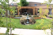 Willowbend Healthcare and Rehabilitation exterior with central fountain and landscaped courtyard.