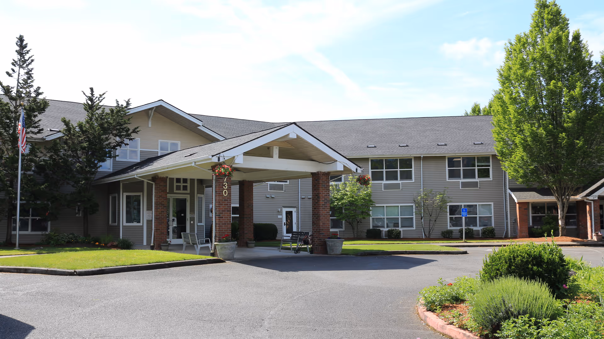 Exterior view of Avamere at Newberg building with entrance canopy and landscaped grounds.