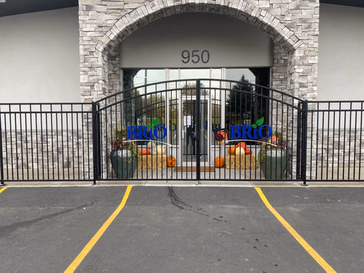 Front entrance of BRiO Home Health and Hospice with pumpkins and decorative planters.