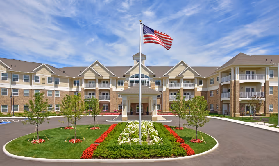 Rose Senior Living Avon exterior building with flagpole, landscaped circle drive, and entrance.