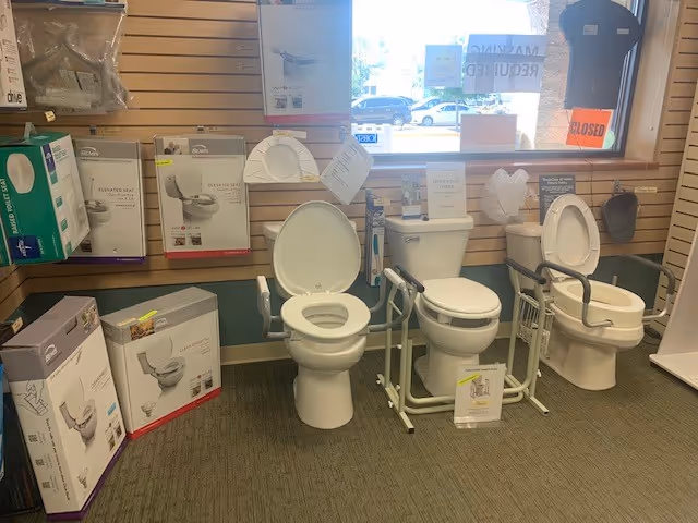 Showroom displays multiple toilet models and bathroom fixtures.