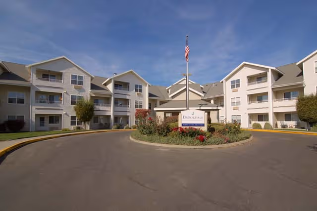 Exterior view of Brookdale Canyon Lakes senior living facility, featuring a circular driveway and landscaped center.