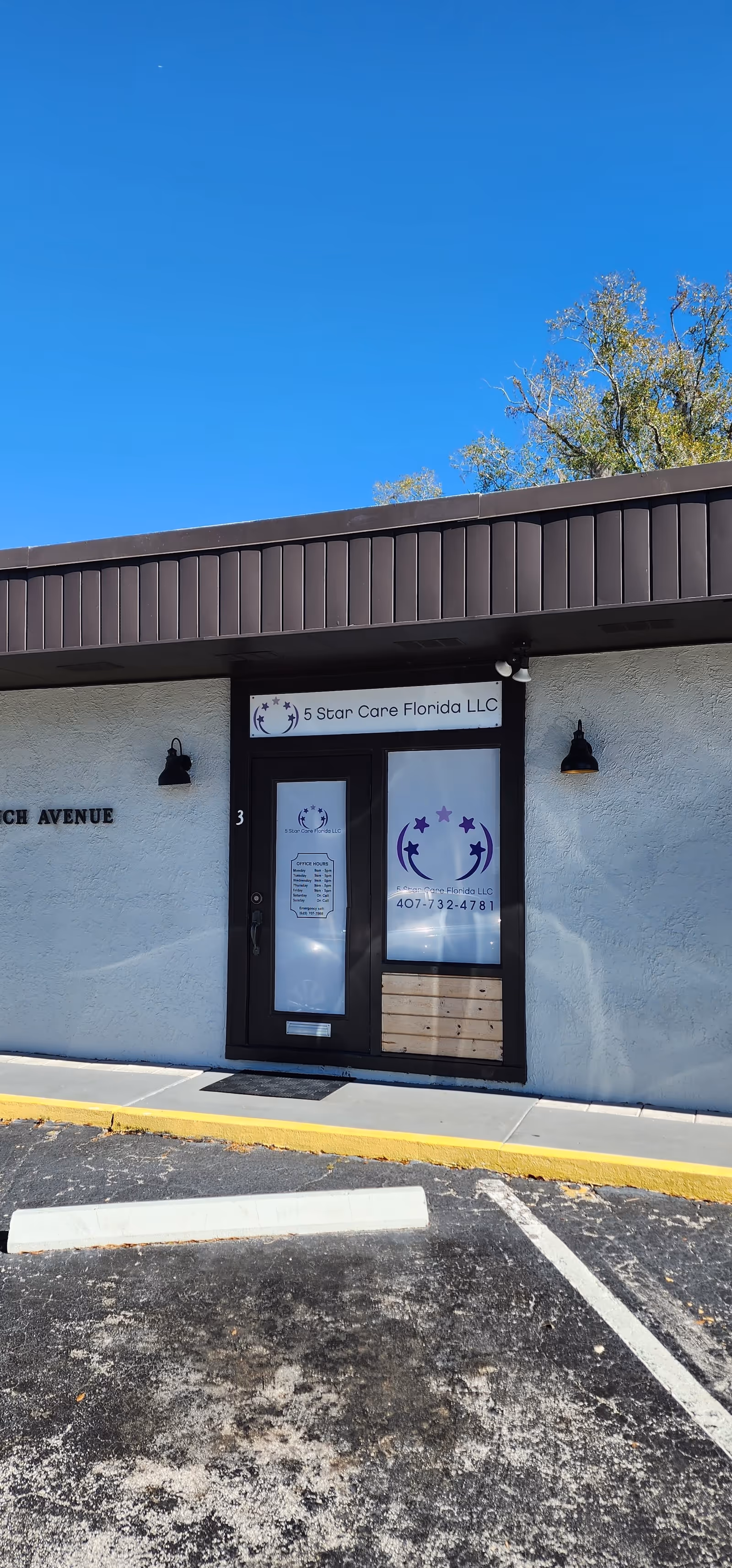 Front of a small building entrance with glass door and 5 Star Care Florida LLC sign.