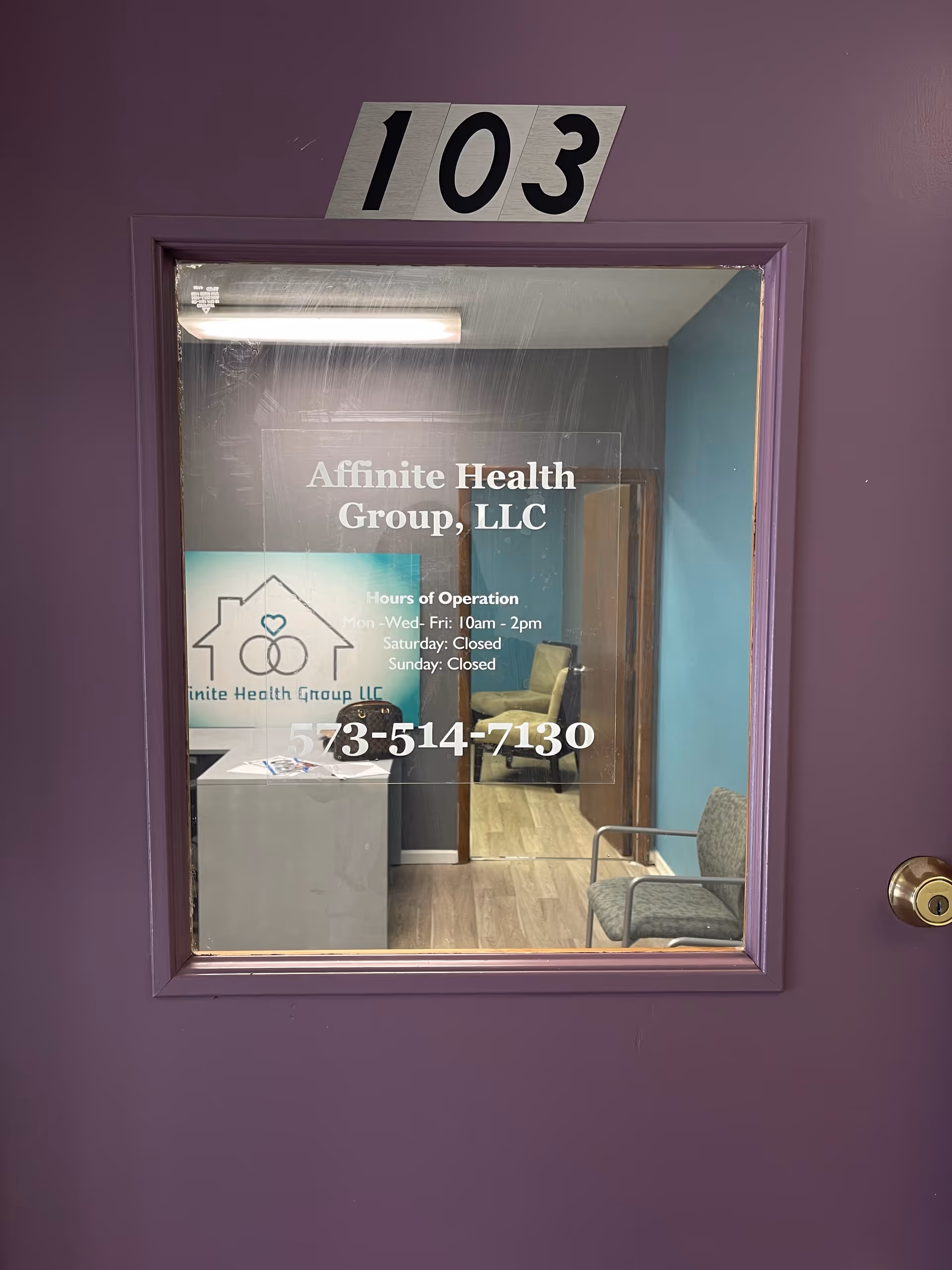 Purple door labeled 103 opens to interior reception with Affinite Health Group, LLC signage.