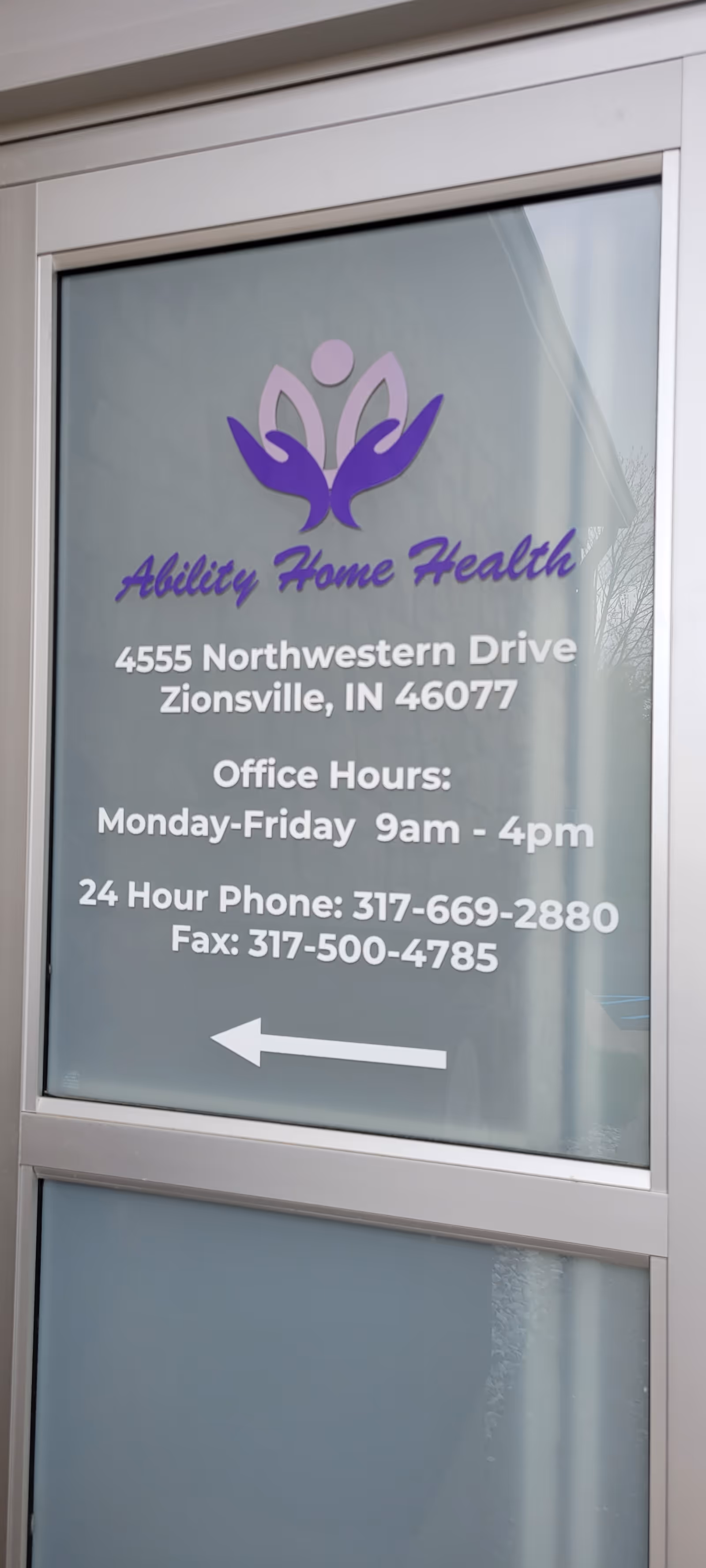 Glass door with Ability Home Health sign, address, hours, and a white arrow.