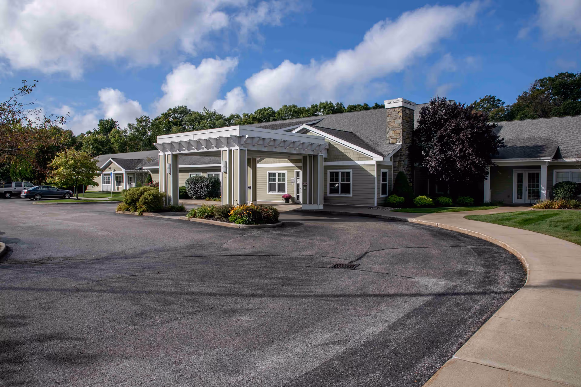 Exterior view of North Ottawa Care Center with a covered entrance and circular driveway in daylight.