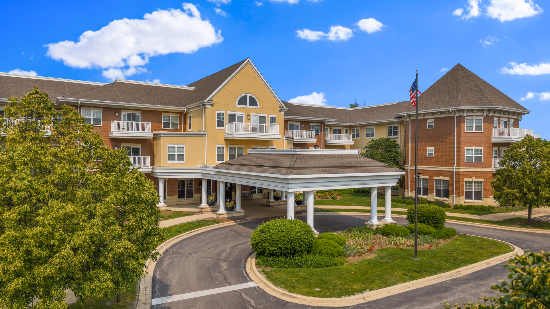 Exterior view of Covenant Living at the Holmstad showing the entrance canopy and circular drive