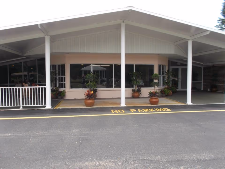 Facade of Bethesda on Turkey Creek with a covered entrance and potted plants.