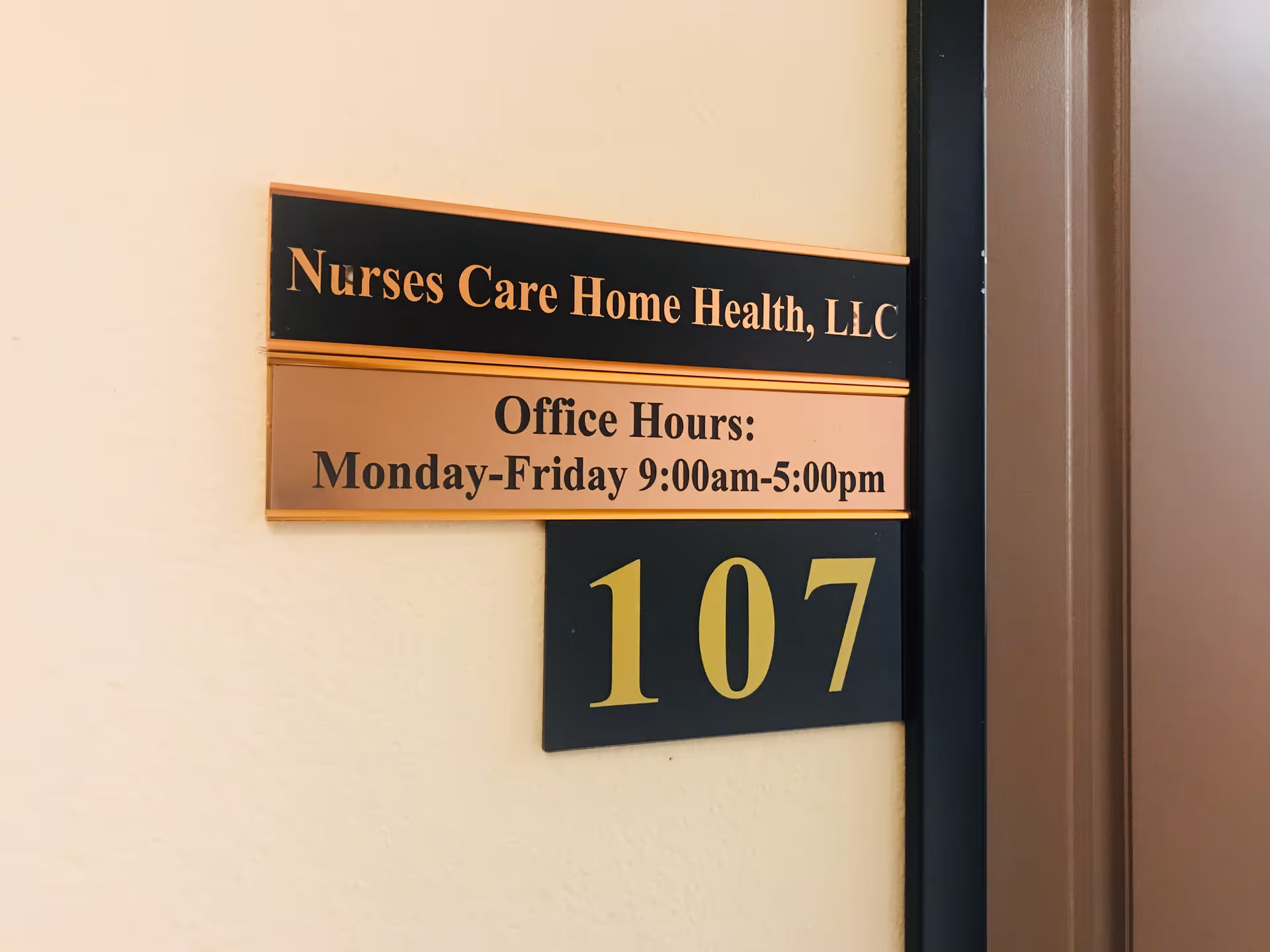 Interior wall sign for Nurses Care Home Health, LLC with office hours and number 107