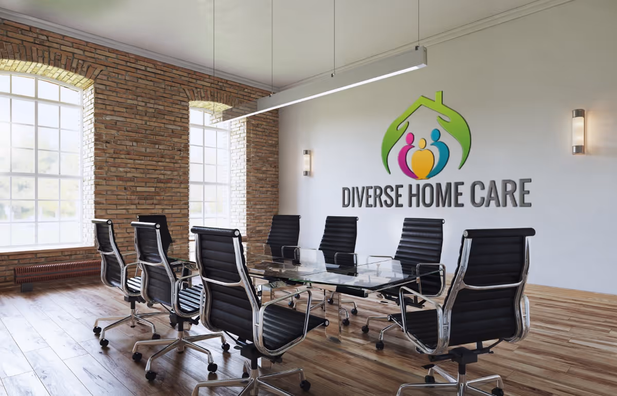 Modern conference room with glass table, black chairs, brick pillars, and Diverse Home Care logo.