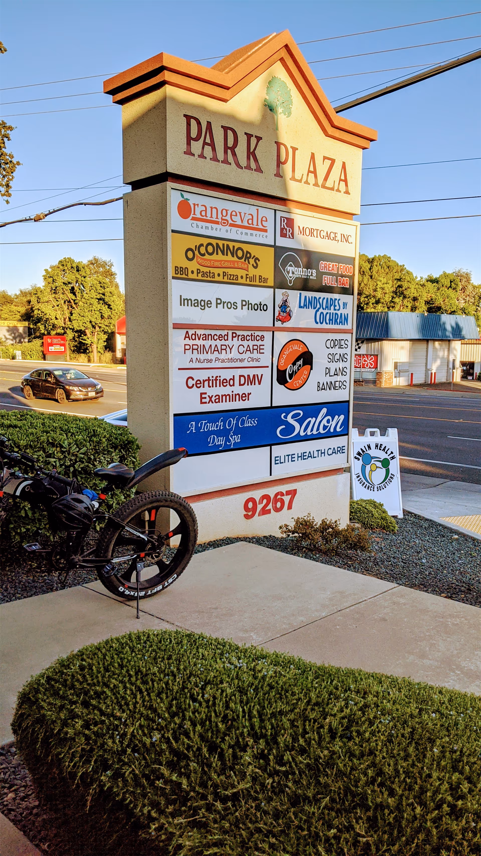 Tall outdoor signboard for Park Plaza featuring Elite Health Care