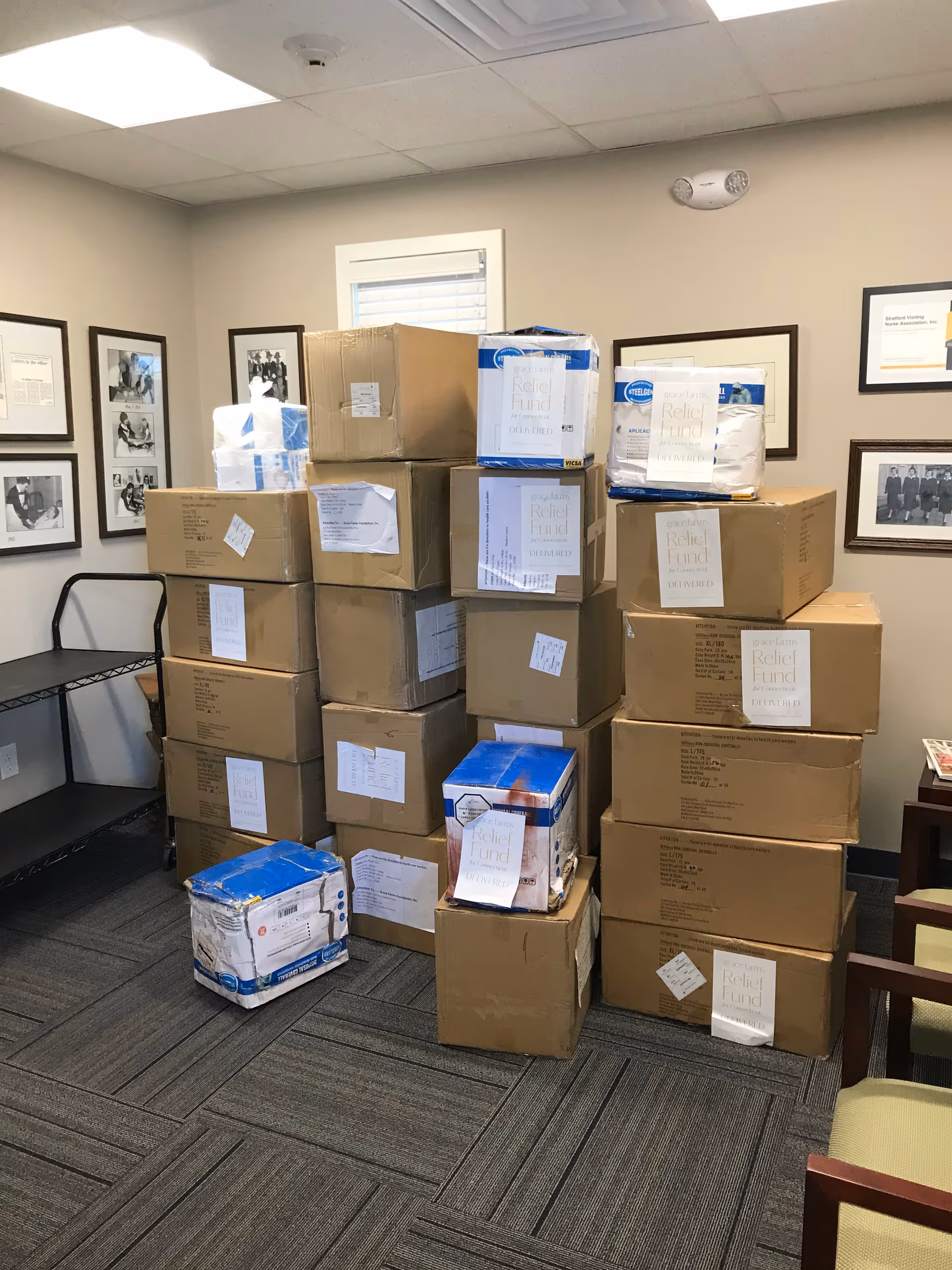 Stacked boxes and supplies fill a small office storage room at Stratford Visiting Nurse Association.