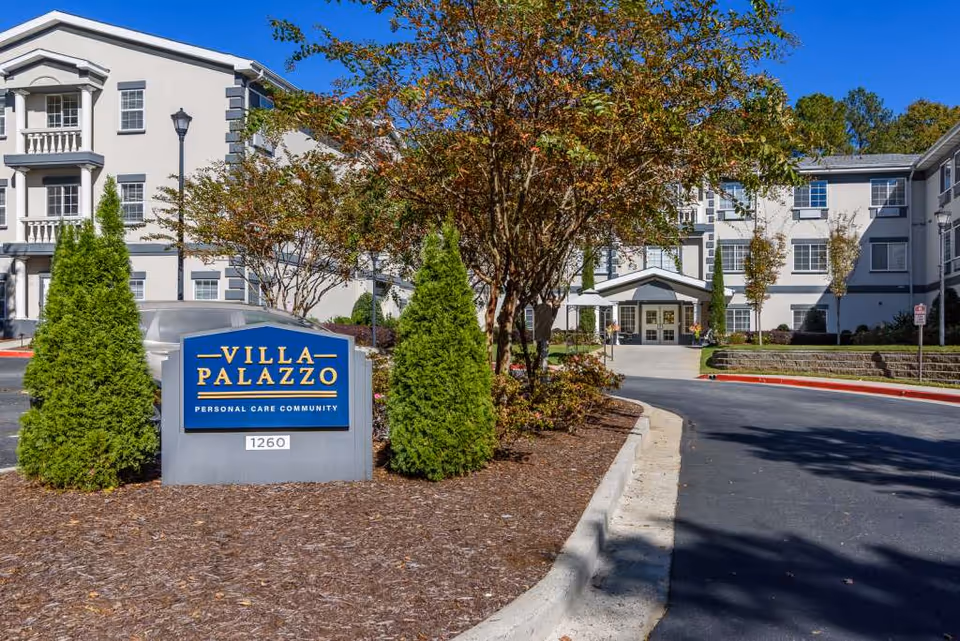 Front exterior of a senior living building with a Villa Palazzo sign.