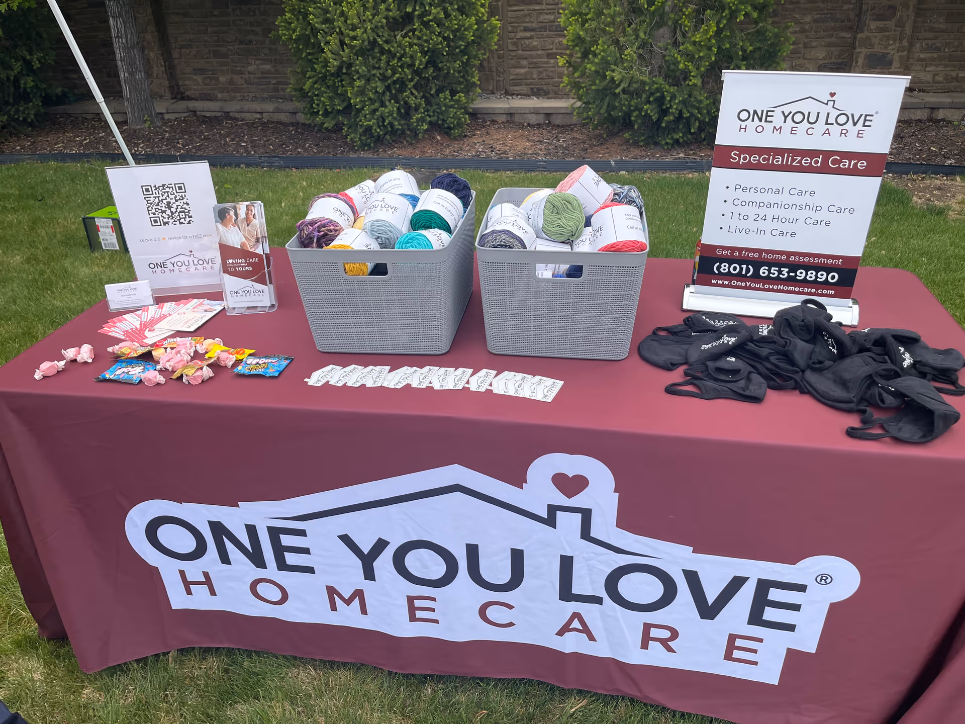 Outdoor table with promotional materials for One You Love Homecare Utah.
