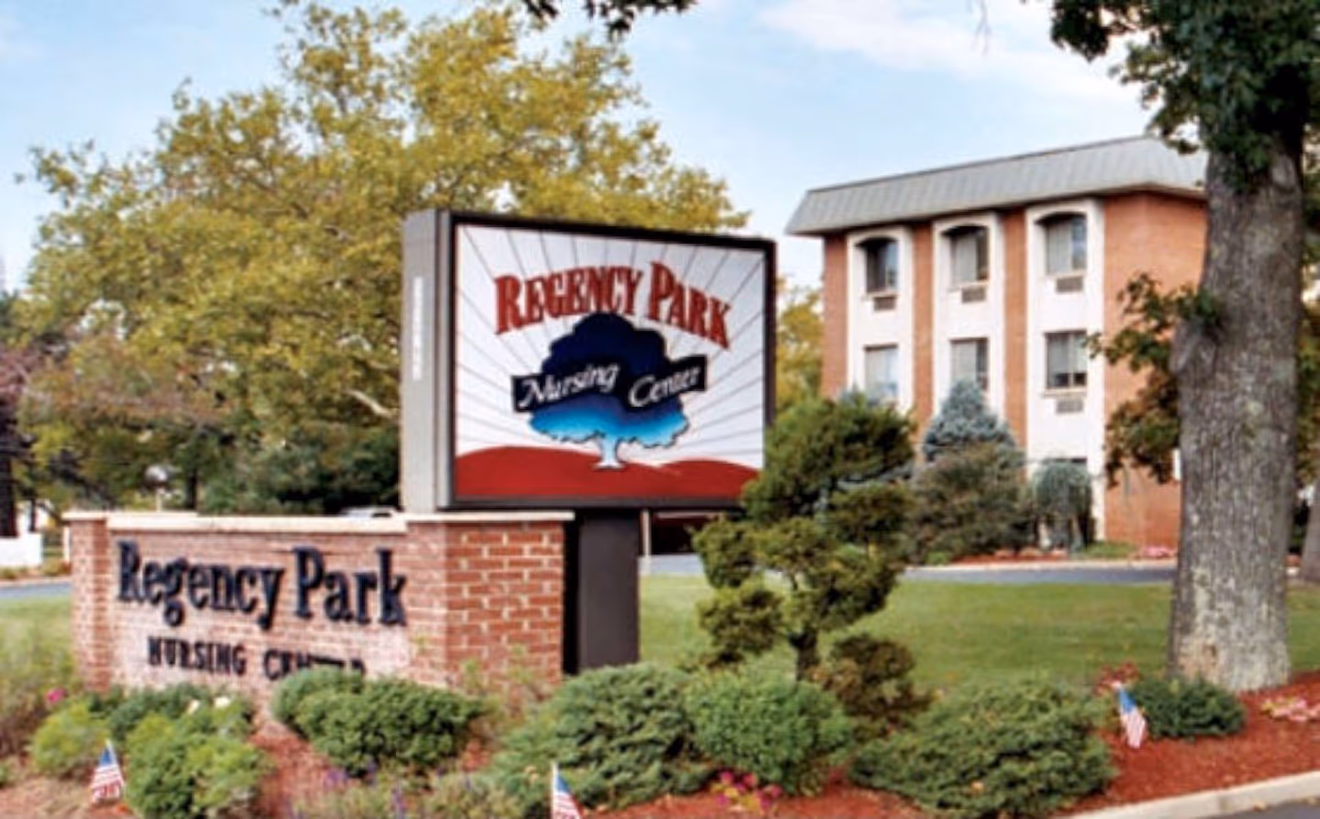 Exterior view of Regency Park Nursing Center sign with brick monument and building