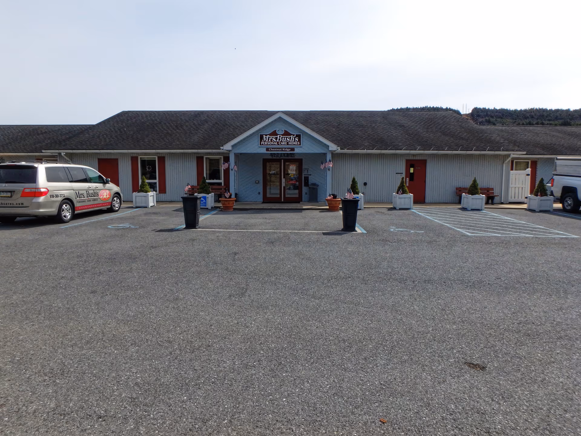 Exterior of Mrs Bushs Personal Care Homes with parked cars and entrance