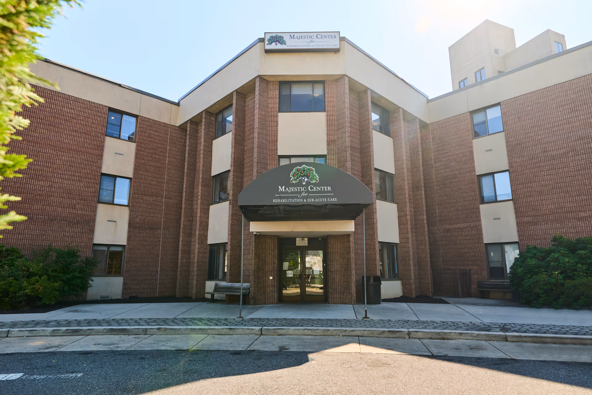 Brick Majestic Center building with glass doors and a curved entrance canopy.