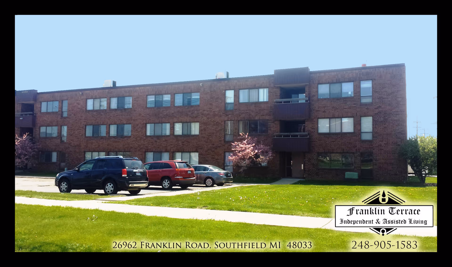 Brick multi-story senior living building with a parking lot and green lawn.
