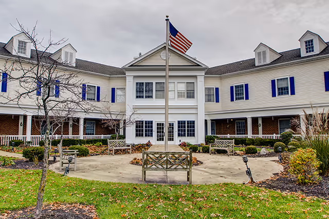 Front view of Brookdale Finneytown senior living facility with a central entrance and flagpole.