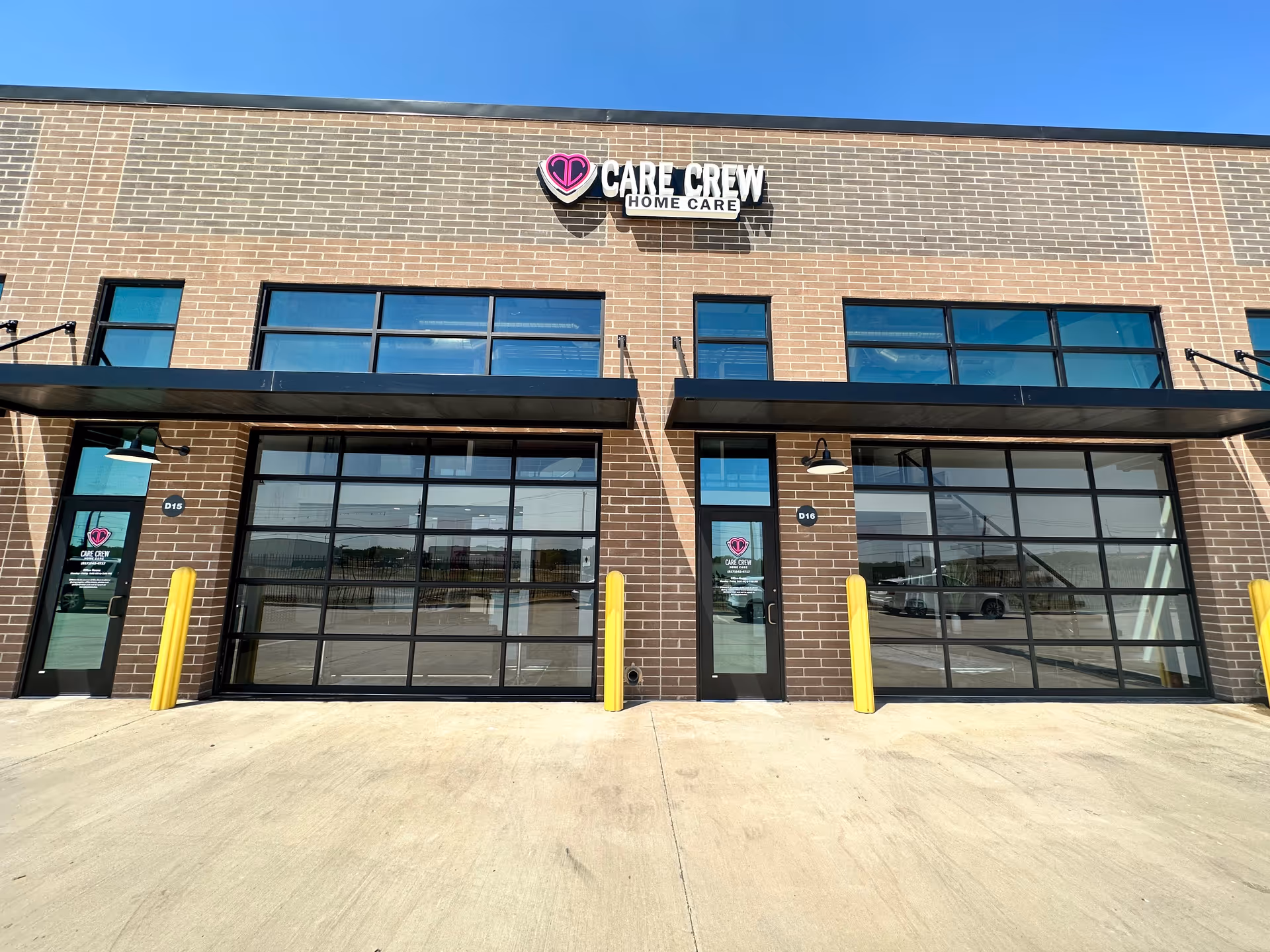 Exterior view of Care Crew Home Care storefront with large glass garage doors.