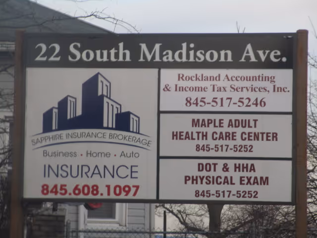 Exterior building signboard displaying Maple Adult Health Care Center and other services.