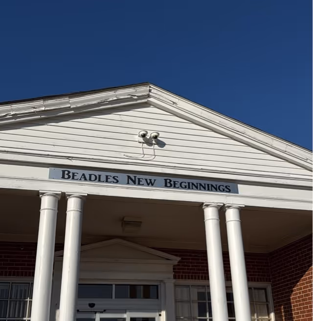 White building front with columns and a sign reading Beadles New Beginnings.