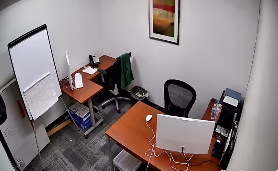 Small Chrisvic Care office with desks, computer, whiteboard, and office supplies.