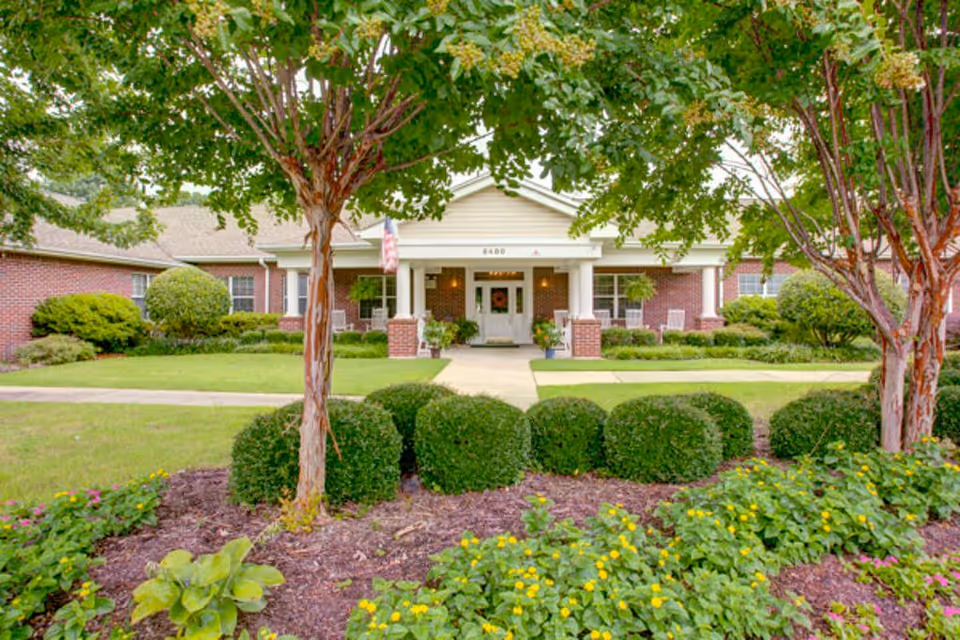 Front entrance of The Pointe at Kirby Gate Assisted Living and Memory Care, with brick exterior.
