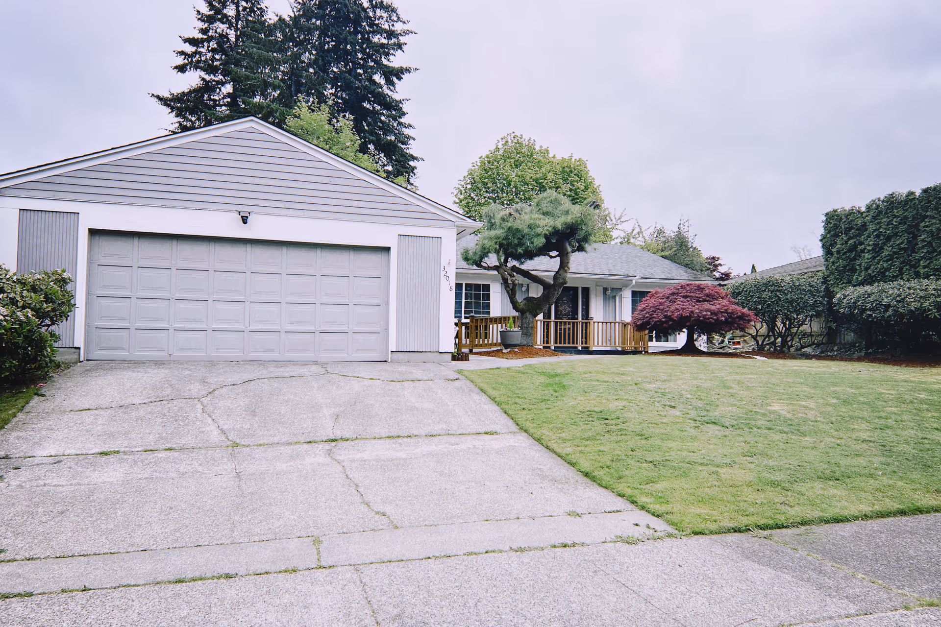 Exterior view of Peace Bridge Adult Family Home with a front garage and lawn.