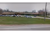 Front exterior view of Leonardville Nursing Home with parked cars in front.