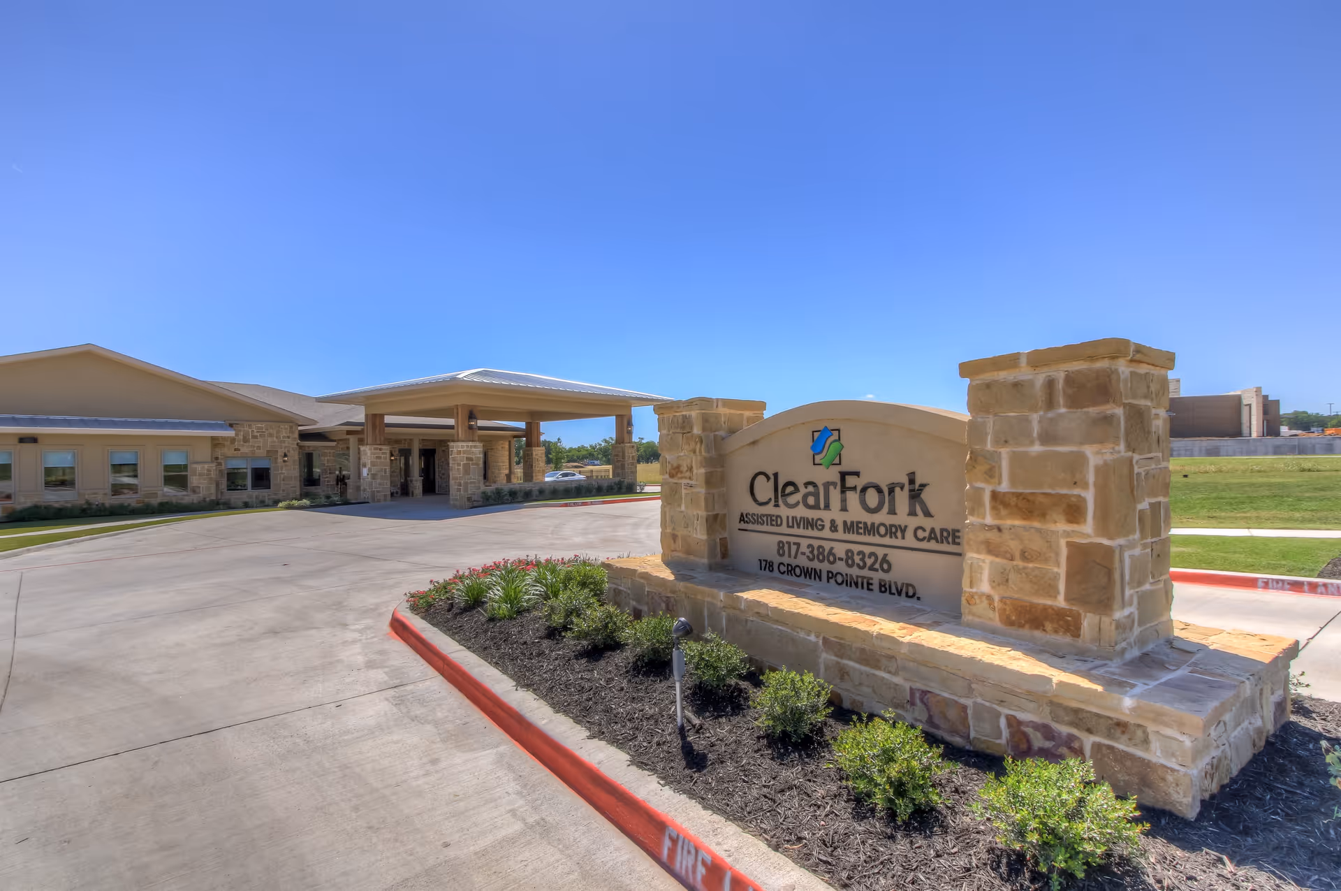 Exterior view of the Clear Fork Assisted Living and Memory Care sign at the facility entrance.