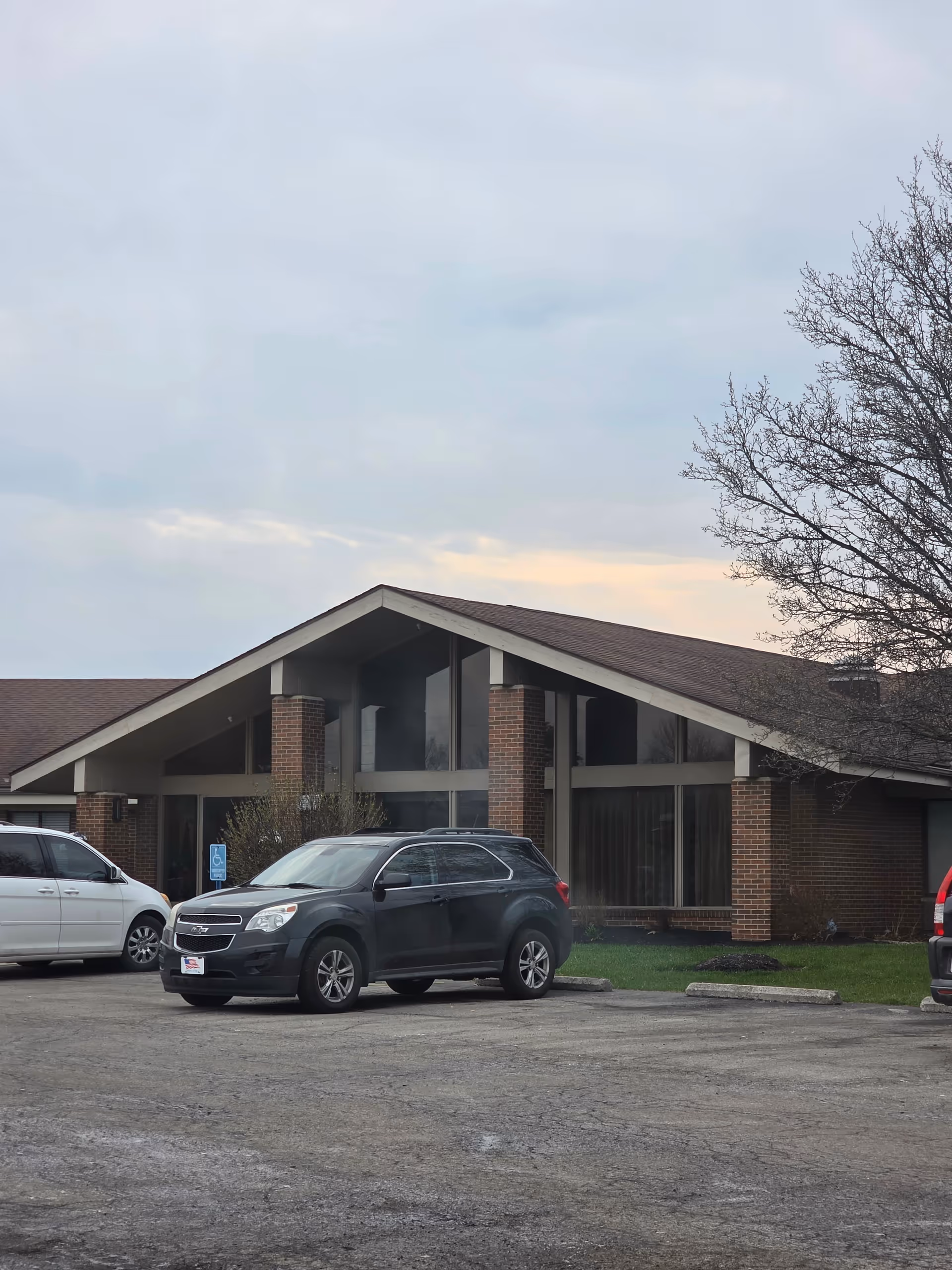 Bellefontaine senior living building exterior with a parking lot in front.