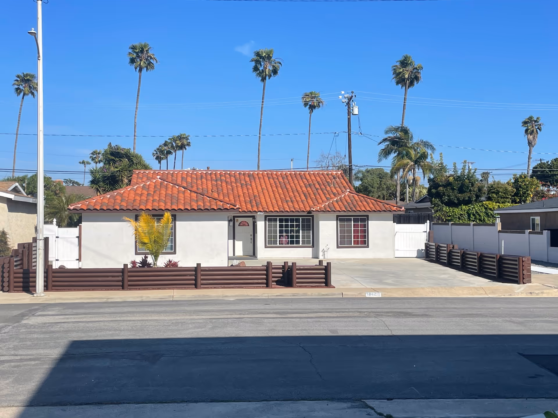 Front view of Huntington Beach Villa: single-story with red tile roof.