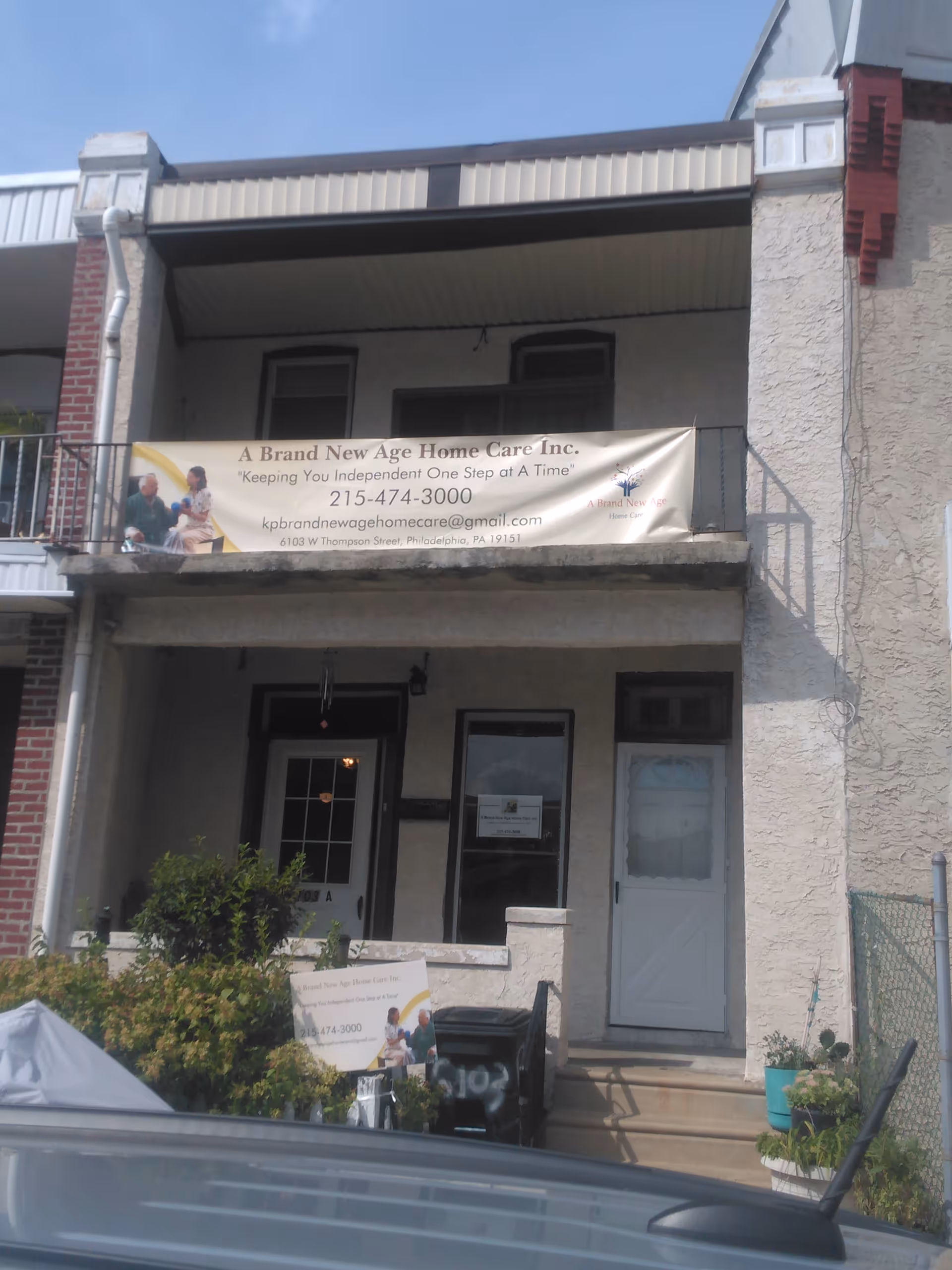 Front facade of a two-story building with a banner for A Brand New Age Home Care.
