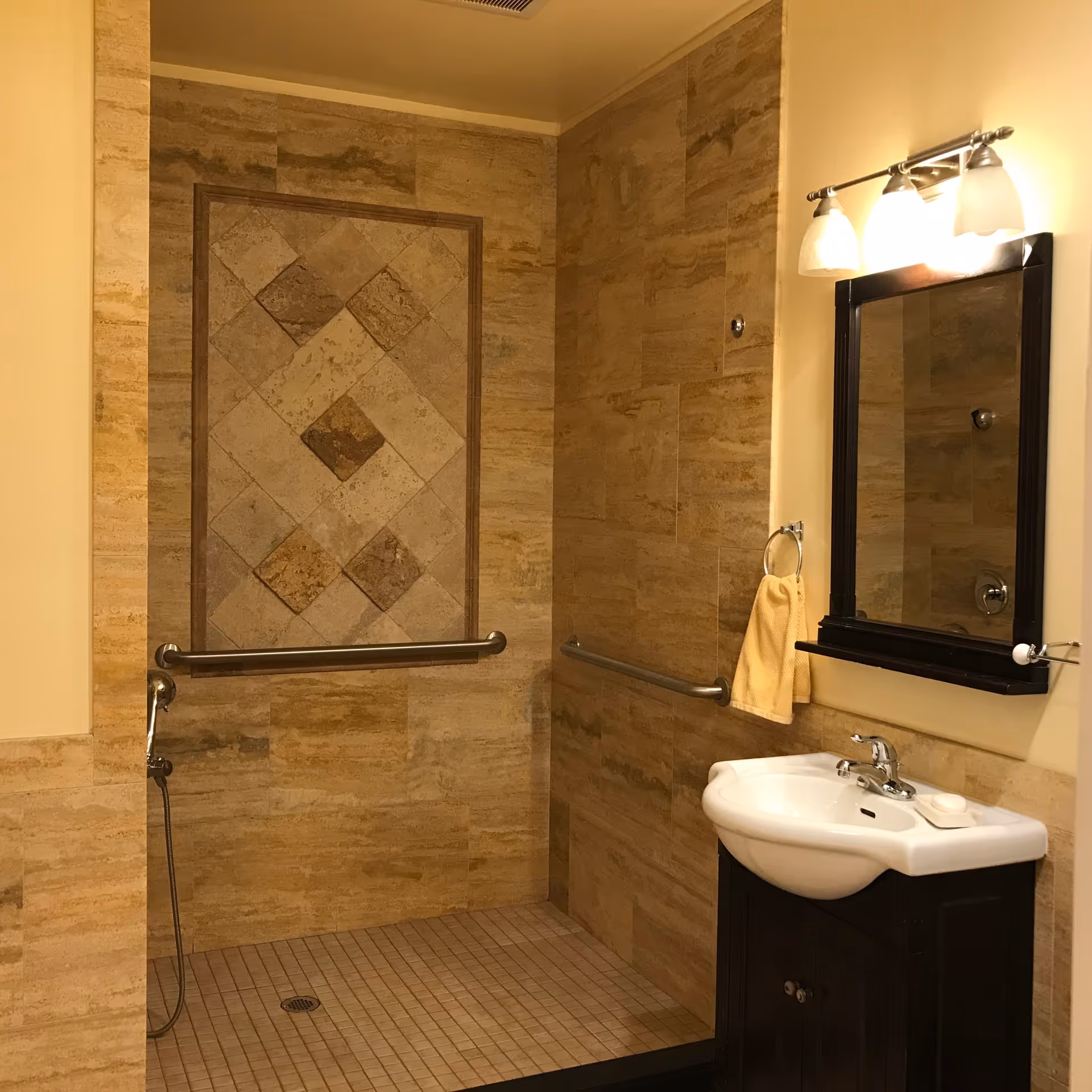 Accessible bathroom with tan tile walls, safety rails, sink, and a mirror.